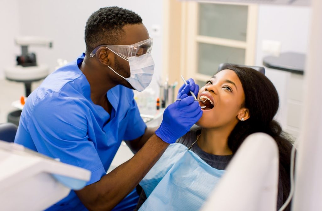 Woman having her teeth examined because of tooth pain