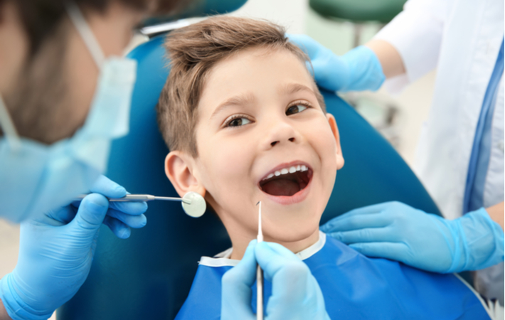 Young boy undergoing dental examination by his dentist