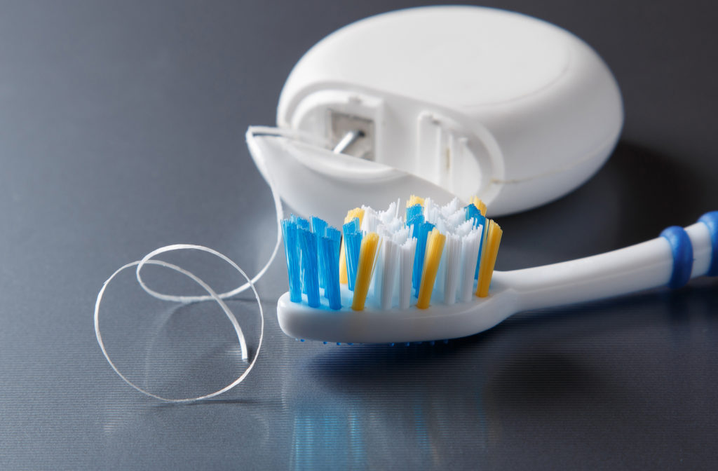 Close up of toothbrush and dental floss