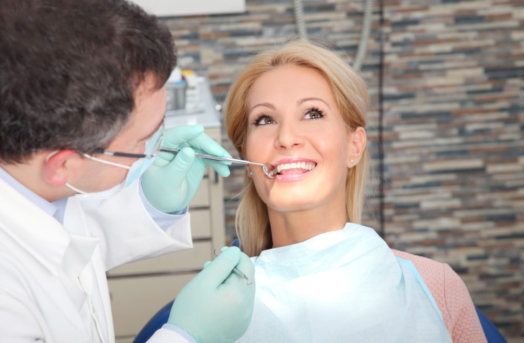 Women having teeth examined by dentist with open mouth