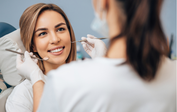 Women sittings on chair ready to be examined by dentist during dental exam