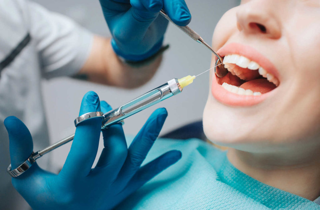 A close up of a dental patient receiving localized freezing before a dental procedure.