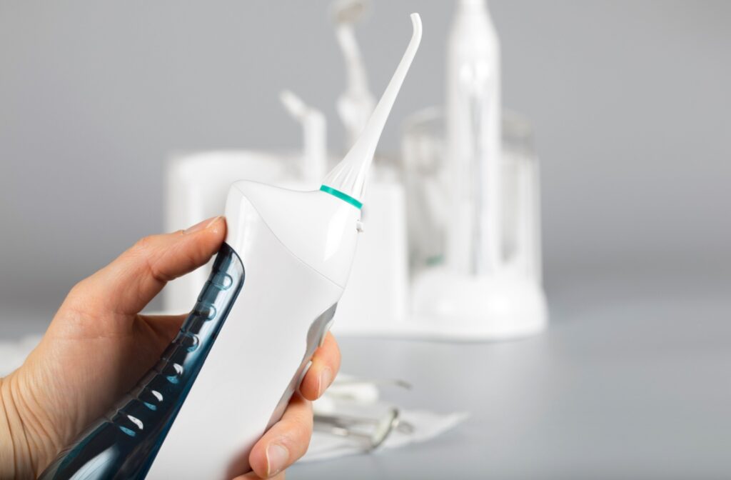 A close-up image of someone getting ready to use their water flosser.