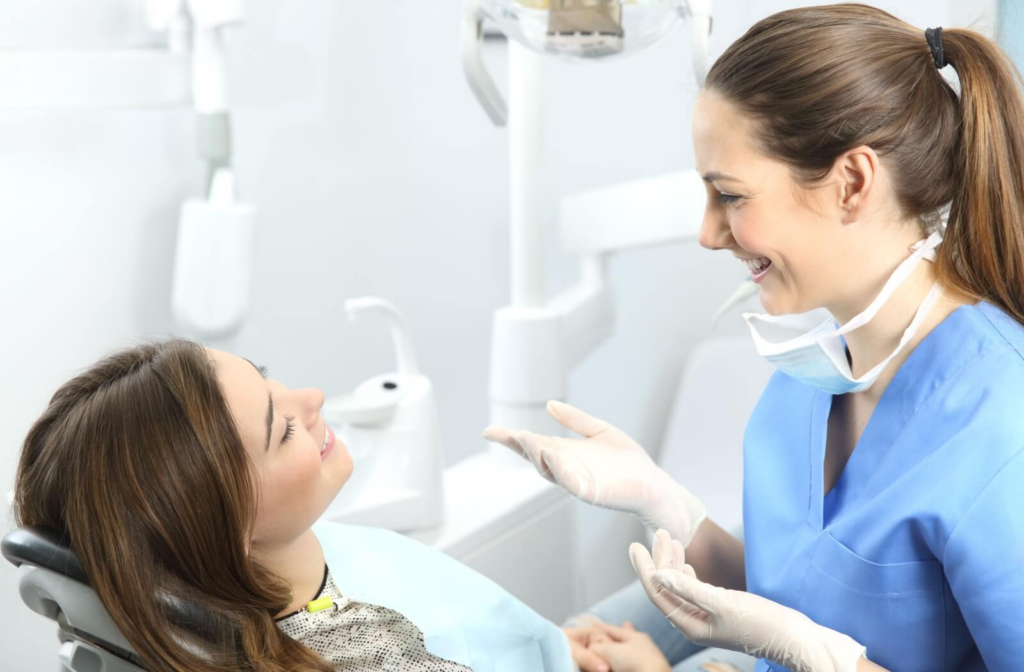 Dentist giving a patient post-op care instructions after a molar extraction.
